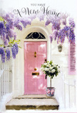 This image portrays a Leamouth doorway made tender and poetic through the careful use of colour and flowers. A blush-pink front door occupies the centre, its tone muted yet cheerful, like a subtle splash of warmth against the crisp white of the surrounding walls. The paint catches the light that might be drifting in from the nearby River Lea, creating a soft sheen that makes the entrance feel inviting even from a distance. Overhead, a lush curtain of wisteria cascades down, its blossoms a blend of lavender and pale purple, with each cluster forming a loose, trailing chain that softens the doorway's straight lines. The imagined scent is sweet and powdery, suggesting late spring or early summer in Leamouth, when balconies and small front gardens begin to overflow with bloom. At the doorstep, a compact grey tin bucket anchors the composition. It brims with white and cream roses, their rounded, velvety petals unfolding in generous layers that catch small highlights of light. Threads of soft green foliage weave among the blooms, adding contrast and a hint of garden freshness. Around the bucket's base, a delicate pink ribbon is tied into a bow, its colour echoing the pink of the door and completing the pastel harmony. The atmosphere is hushed yet happy, like arriving at a new riverside flat after a long day of moving boxes, to find a floral gift waiting. It feels like a thoughtful housewarming arrangement, perhaps delivered by a local Leamouth florist the same day, ready to fill the new space inside with scent, beauty, and the reassuring sense that this new address is already becoming home.